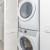stacked washer/dryer closet in bright hallway
