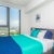 Bedroom with view of harbor from floor-to-ceiling windows